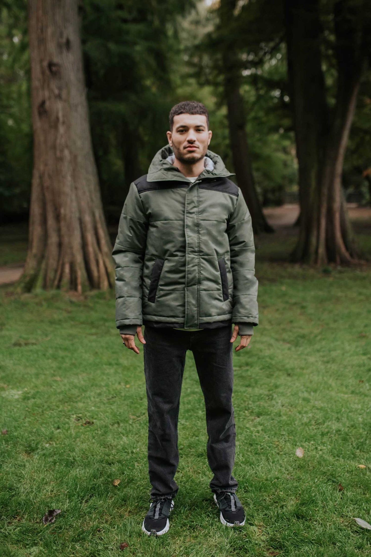 All weather proof sustainable hemp winter jacket, with an adjustable hood, ribbed knit cuffs with thumbholes and zipper windguard to keep the elements out. The soft vegan padding is made from 100% certified recycled plastic bottles, by the innovative Repreve® - Front View Closed